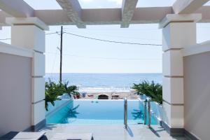 a view of the beach from a building with a swimming pool at Agios Gordios Beach Resort in Agios Gordios