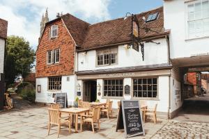 a restaurant with tables and chairs in front of a building at The Woolpack Hotel in Tenterden
