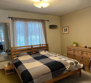 a bedroom with a large bed and a window at Vrijstaand huis in Västerbotten in Norsjö