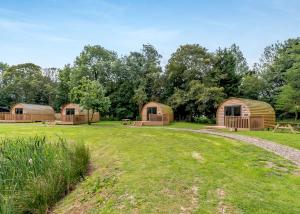 a group of wooden huts in a field at Killerby Old Hall in Scarborough