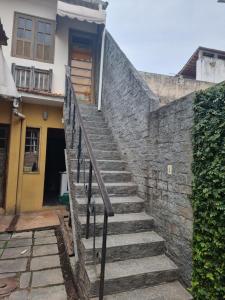a set of stairs leading up to a house at Suite em Paquetá in Rio de Janeiro