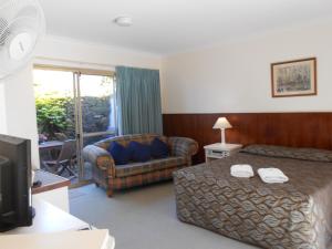 a hotel room with a bed and a couch at Augusta's Georgiana Molloy Motel in Augusta