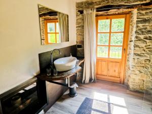 a bathroom with a sink on a table with a window at B&B Barbaia in Levice