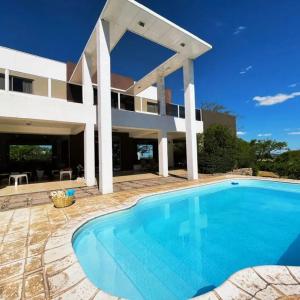 a large swimming pool in front of a house at QHAWANA CABAÑAS & SUITES in La Rioja