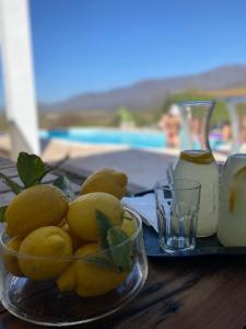 a bowl of lemons on a table next to a tray at QHAWANA CABAÑAS & SUITES in La Rioja