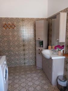 a bathroom with a sink and a toilet at Residence Carlini in Passoscuro