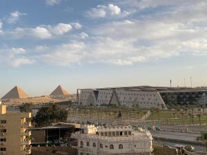 a view of the pyramids of giza and the city at Malika Egyptian Museum View in Cairo