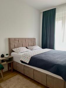 a bedroom with a large bed and a window at Apartment Llama in Trebinje