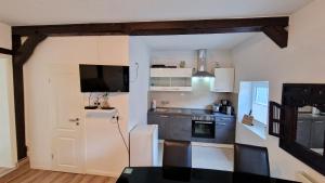 a kitchen with a white refrigerator and a stove top oven at Schöne Einliegerwohnung im Fachwerkhaus in Meinersen