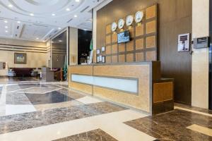 a lobby of a hotel with clocks on the wall at Al Rayyan Towers 1 in Mecca