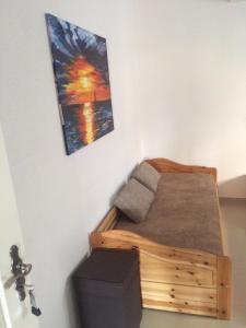 a bedroom with a wooden bed and a painting on the wall at Apartments Lucija in Brela
