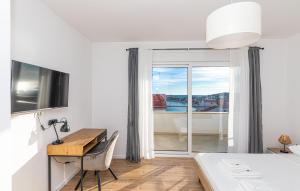 a bedroom with a desk and a bed and a bed and a window at Beautiful Home In Sevid Na Moru in Sevid