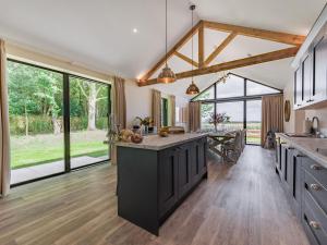 an open kitchen with a large island in the middle at Partridge in East Ilsley