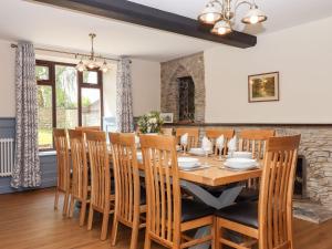 a dining room with a wooden table and chairs at Nempnett Farmhouse in Bristol