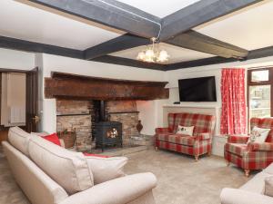 a living room with couches and a fireplace at Nempnett Farmhouse in Bristol