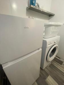 a kitchen with a washing machine and a washer at The Home Away From Home in Great Harwood