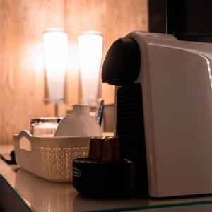 a toaster sitting on a counter next to a bowl at The Hotel Unforgettable - Hotel Tiliana by Homoky Hotels & Spa in Budapest