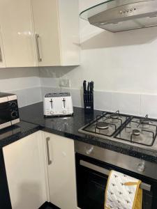a kitchen with a stove and a counter top at The Home Away From Home in Great Harwood