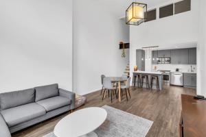 a living room with a couch and a table at Stylish 2BR Loft - Carroll Gardens - Prime area in Brooklyn