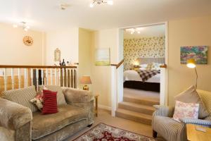 a living room with a couch and a bedroom at Penbontbren Luxury Bed and Breakfast in Aberporth