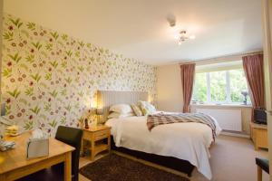a bedroom with a bed and a desk at Penbontbren Luxury Bed and Breakfast in Aberporth