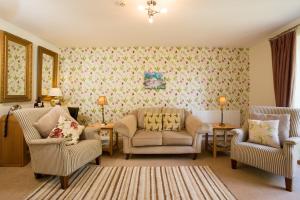 a living room with two chairs and a couch at Penbontbren Luxury Bed and Breakfast in Aberporth