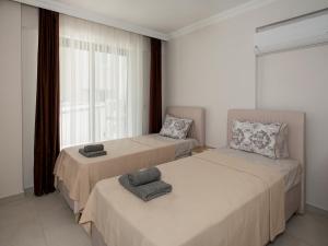 dwa łóżka w pokoju z oknem w obiekcie VİLLA BLUE CRAB w mieście Ortaca