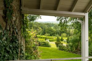 an open porch with a view of a garden at Penbontbren Luxury Bed and Breakfast in Aberporth