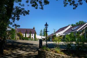 a street with houses and a street light in a village at Penbontbren Luxury Bed and Breakfast in Aberporth