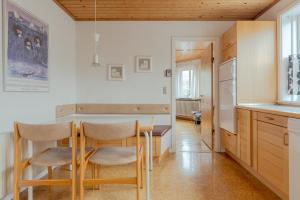 a kitchen with a table and chairs in a room at The Cookie Store Guesthouse in Tórshavn