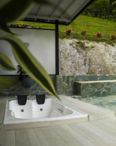 a white bath tub sitting on top of a patio at Zoi Eco Hotel in Manizales