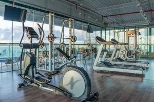 a gym with several treadmills and exercise bikes at Sotero Hotel by Castelo Itaipava in Salvador