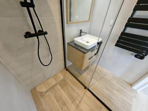 a small bathroom with a sink and a shower at Jolie maison entierement renovee proche centre vil in Panazol