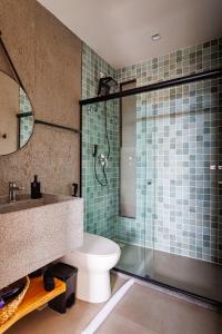 a bathroom with a shower and a toilet and a sink at Pysá Zero Um in São Miguel dos Milagres +20 photos