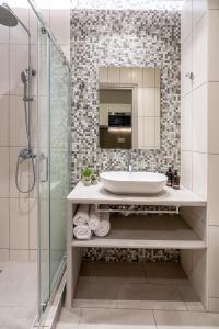 a bathroom with a sink and a glass shower at Luxury 101 Studio apartment in central Athens in Athens