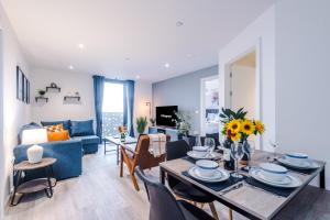 a dining room and living room with a table and chairs at NEW! Pristine 2-Bed Flat on Liverpool by 53 Degrees Property, Amazing Location, Sleeps 6! in Liverpool