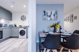 a kitchen and dining room with a table and chairs at NEW! Pristine 2-Bed Flat on Liverpool by 53 Degrees Property, Amazing Location, Sleeps 6! in Liverpool
