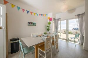 a dining room with a table and chairs at Absolute Beachfront with Decked Garden Oasis and Views in Bognor Regis