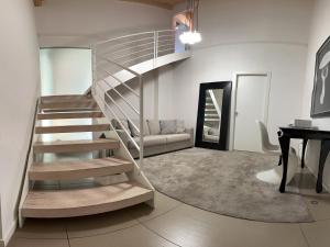 a spiral staircase in a living room with a desk at Villa Fiorentino in Rossano