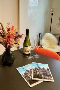 a table with a bottle of wine and two glasses at J1 - Urban studio in Antwerp in Antwerp