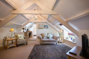 a living room with a ceiling with beams at Penbontbren Luxury Bed and Breakfast in Aberporth
