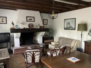 a living room with a couch and a fireplace at Piraillan Foret - Réf 2064 in Lège-Cap-Ferret