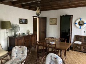 a living room with a dining room table and chairs at Piraillan Foret - Réf 2064 in Lège-Cap-Ferret