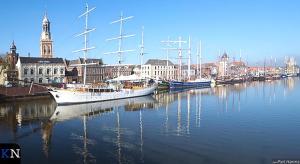 a group of boats are docked in a harbor at De Stadsboerderij in Kampen