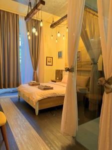 a bedroom with a bed in a room with curtains at Boutique Guest House Yes For You in Plovdiv