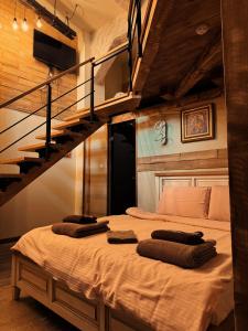 a bedroom with a large bed with a staircase at Boutique Guest House Yes For You in Plovdiv