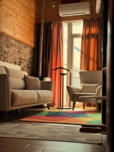 a living room with a couch and two chairs at Boutique Guest House Yes For You in Plovdiv