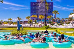 a group of people riding on tubes in the water at a resort at Aqualand Park & Resort Oficial in Salinópolis