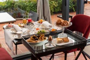 a table with a tray of breakfast food on it at Dimora Cordero in Priocca