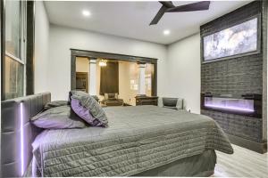 a bedroom with a large bed and a flat screen tv at New Orleans Duplex 2 Mi to Bourbon Street! in New Orleans